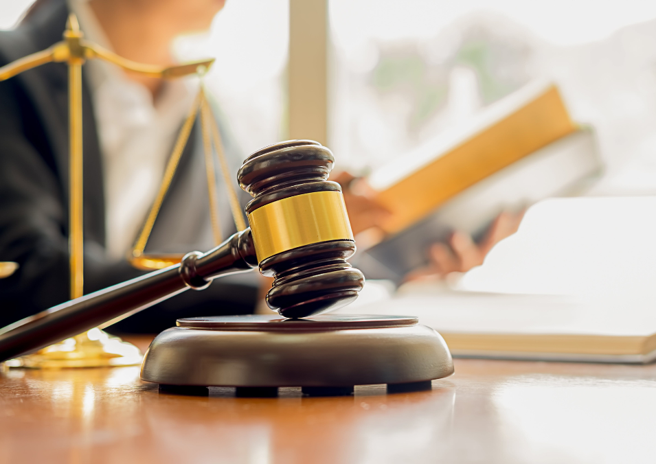 A lawyer's desk featuring a gavel, symbolizing justice and court reporting in a professional legal setting.