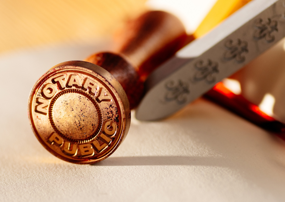  A rubber stamp rests on a piece of paper, symbolizing Notary Public Services and official documentation